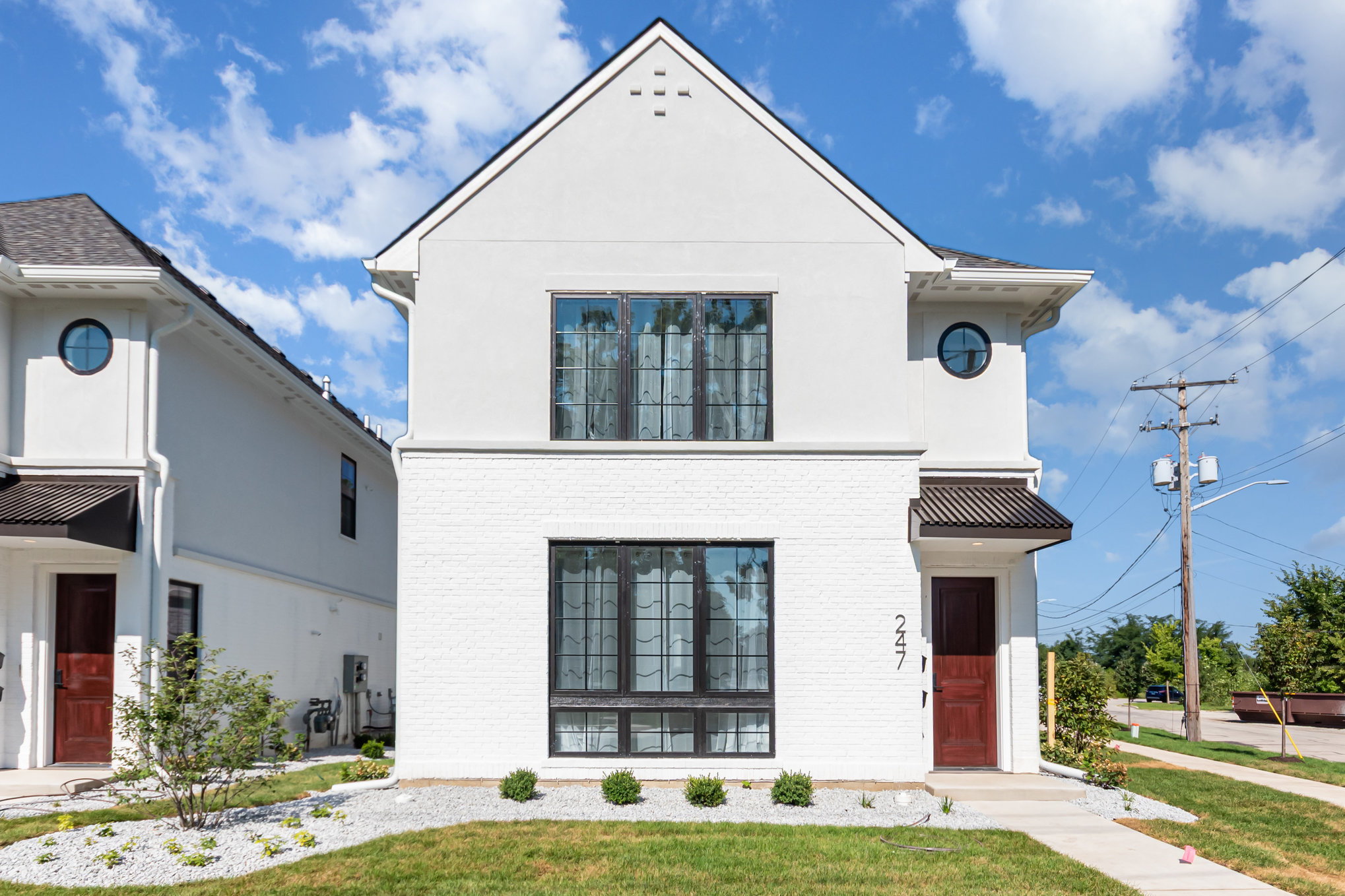 Local Chicago suburb custom home builders. Custom built white home with red door.